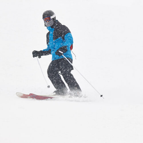 Skiing under the snow. Winter sport. Ski slope. Horizontal